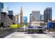Rooftop grilling area featuring two stainless steel grills with city views in the background at 1020 15Th St # 20N, Denver, CO 80202