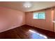 Comfortable bedroom with hardwood floors, a window, and natural light, creating a serene and relaxing atmosphere at 7245 S Dexter St, Centennial, CO 80122