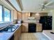 Functional kitchen with updated appliances, tile flooring, and ample counter space, ready for culinary adventures at 7245 S Dexter St, Centennial, CO 80122