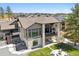 Aerial view of a modern home with outdoor living spaces, a spacious yard, and neighborhood scenery at 5787 Powell Rd, Parker, CO 80134