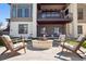 Backyard with a stone fire pit and cozy lounge chairs at 5787 Powell Rd, Parker, CO 80134