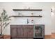 Stylish built-in bar area with wood cabinetry, a beverage cooler, and open shelving at 5787 Powell Rd, Parker, CO 80134