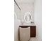 Bright bathroom vanity featuring a lighted makeup mirror, marble tile backsplash, and clean modern lines at 5787 Powell Rd, Parker, CO 80134