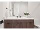 Modern half bath with wood vanity, large mirror, and black hardware at 5787 Powell Rd, Parker, CO 80134