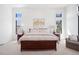 Bright primary bedroom with large windows, neutral tones, carpet and wood furniture at 5787 Powell Rd, Parker, CO 80134