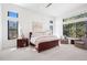 Light-filled bedroom with large windows, neutral tones, and wood furnishings at 5787 Powell Rd, Parker, CO 80134