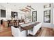 Modern dining area featuring a long wooden table and white chairs adjoining the kitchen at 5787 Powell Rd, Parker, CO 80134