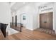 Bright foyer boasting hardwood floors and a modern chandelier at 5787 Powell Rd, Parker, CO 80134