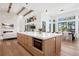 Bright, open kitchen with large island, wooden cabinets, and stainless steel microwave at 5787 Powell Rd, Parker, CO 80134