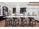 Contemporary kitchen featuring sleek countertops, dark cabinets, and pendant lighting at 5787 Powell Rd, Parker, CO 80134