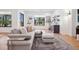 Open concept living room with light hardwood floors, neutral decor, and backyard views at 5787 Powell Rd, Parker, CO 80134