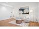 Bright sitting area with white walls, light hardwood floors, and modern decor at 5787 Powell Rd, Parker, CO 80134