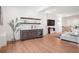 Open-concept living space with built-in bar, shelving, hardwood floors, and neutral tones at 5787 Powell Rd, Parker, CO 80134