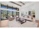 Living room with view to green trees through expansive windows at 5787 Powell Rd, Parker, CO 80134