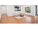 Bright sitting area with white walls, light hardwood floors, and modern decor at 5787 Powell Rd, Parker, CO 80134