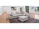 Open concept living room with light hardwood floors, neutral decor, and backyard views at 5787 Powell Rd, Parker, CO 80134