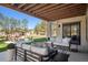 Covered patio with outdoor seating, lush greenery, and a fire pit in backyard at 5787 Powell Rd, Parker, CO 80134