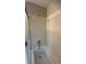 Bathroom with white tiled walls, a bathtub, and a shower with glass door at 5030 Beach Ct, Denver, CO 80221