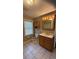 Cozy bathroom with tiled floor, classic vanity with wooden cabinets, and a toilet at 5030 Beach Ct, Denver, CO 80221