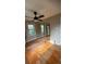 Bedroom with hardwood floors, a ceiling fan, and a mirrored closet at 5030 Beach Ct, Denver, CO 80221