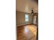 Bedroom with hardwood floors, a ceiling fan, and a door at 5030 Beach Ct, Denver, CO 80221