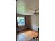 Bedroom with hardwood floors, a ceiling fan, and a large window at 5030 Beach Ct, Denver, CO 80221