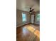 Bedroom with hardwood floors, a ceiling fan, two windows, and a door at 5030 Beach Ct, Denver, CO 80221