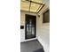 Inviting entrance featuring a black screen door, a light fixture, and white siding at 5030 Beach Ct, Denver, CO 80221