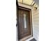 Elegant brown front door with decorative glass panel and secure locking mechanism at 5030 Beach Ct, Denver, CO 80221
