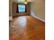 Spacious living room with hardwood floors, a ceiling fan, and a window with curtains at 5030 Beach Ct, Denver, CO 80221