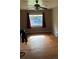 Empty living room with hardwood floors, a ceiling fan, and a window with curtains at 5030 Beach Ct, Denver, CO 80221
