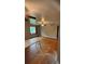 Open-concept living room with hardwood floors, ceiling fan, and ample natural light at 5030 Beach Ct, Denver, CO 80221