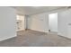 Unfinished basement with carpet, storage and access to stairs at 9105 Oberon Rd # 2, Arvada, CO 80004