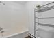 Bathroom with shower/tub combo and metal shelving unit at 9105 Oberon Rd # 2, Arvada, CO 80004