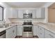 Modern kitchen with stainless steel appliances and gray cabinets at 9105 Oberon Rd # 2, Arvada, CO 80004