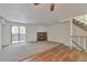 Spacious living room with wood-look floors, fireplace, and carpet at 9105 Oberon Rd # 2, Arvada, CO 80004