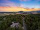 Beautiful aerial view of the property featuring a mountain view at sunset at 4491 Shoshone Dr, Larkspur, CO 80118