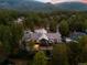 Expansive aerial view of the home surrounded by trees, with mountain views at 4491 Shoshone Dr, Larkspur, CO 80118