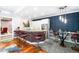 Charming basement wet bar area with granite counters, stainless steel refrigerator, and bar stool seating at 4491 Shoshone Dr, Larkspur, CO 80118
