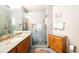 Modern bathroom with a tiled glass walk-in shower and granite vanity at 4491 Shoshone Dr, Larkspur, CO 80118