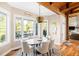 Bright dining area with large windows, stylish lighting, and seating for six at 4491 Shoshone Dr, Larkspur, CO 80118