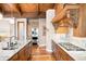 Bright kitchen with granite countertops, stainless steel appliances and wood flooring at 4491 Shoshone Dr, Larkspur, CO 80118