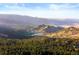 Scenic landscape showing the golf course, hills, and mountains surrounding the property at 4491 Shoshone Dr, Larkspur, CO 80118