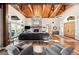 Living room featuring hardwood floors, a stone fireplace, and a beamed wood ceiling at 4491 Shoshone Dr, Larkspur, CO 80118