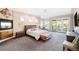 Large main bedroom with private balcony, sitting area and plush carpet flooring at 4491 Shoshone Dr, Larkspur, CO 80118