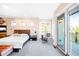 Bright main bedroom with balcony access, sitting area and plush carpet flooring at 4491 Shoshone Dr, Larkspur, CO 80118