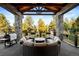 Relaxing outdoor space with stone columns and comfortable seating area at 4491 Shoshone Dr, Larkspur, CO 80118