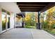 Covered patio boasts stone pillars and an inviting view of the surrounding trees and landscape at 4491 Shoshone Dr, Larkspur, CO 80118