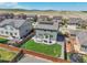 Aerial view showcasing the well-kept backyard with a patio, green lawn, and privacy fencing at 7888 E 139Th Pl, Brighton, CO 80602