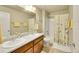 Bathroom features double sinks and a shower and bath at 7888 E 139Th Pl, Brighton, CO 80602